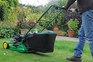 Mowing a lawn with a petrol mower
