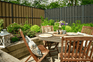 Table, chairs and fencing in a garden